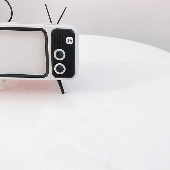 Mobile Phone Screen Stand. with Speaker Function. It can be Connected by Bluetooth or by Wire. Without The Screen Magnifier Function. But More Practical Than a Screen Magnifier. A Smart Gift for